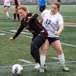 Kenai Centrals Kylee Verkuilen battles for the ball with Soldotnas Liberty Miller during the Division II Soccer State Championship on Saturday, May 27, 2023, at West Anchorage High School in Anchorage, Alaska. (Jake Dye/Peninsula Clarion)