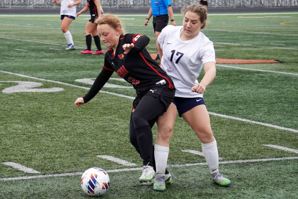 Kenai Centrals Kylee Verkuilen battles for the ball with Soldotnas Liberty Miller during the Division II Soccer State Championship on Saturday, May 27, 2023, at West Anchorage High School in Anchorage, Alaska. (Jake Dye/Peninsula Clarion)