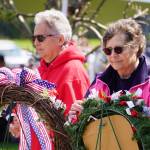 Attendees affix poppies to wreaths during a Memorial Day ceremony on Monday, May 29, 2023, at Leif Hanson Memorial Park in Kenai, Alaska. (Jake Dye/Peninsula Clarion)