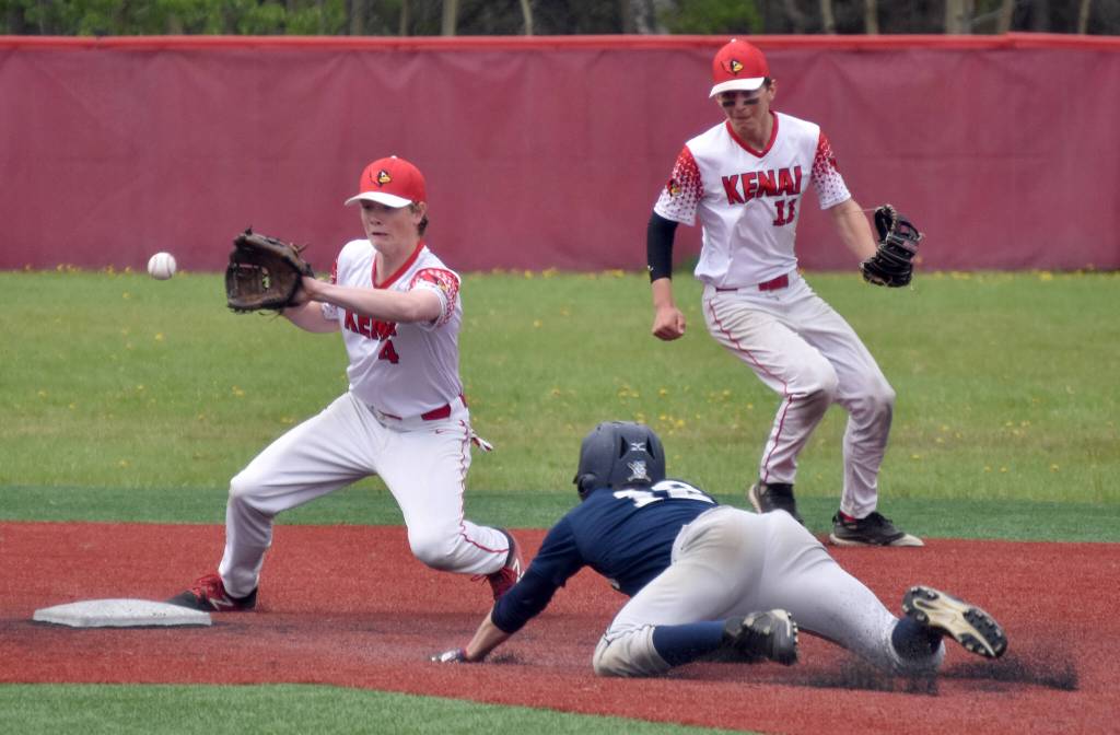 Kenai Centrals Everett Chamberlain gets ready to tag out Soldotnas Levi Mickelson as Braden Smith backs up in the Division II state championship game Saturday, June 4, 2023, at Wasilla High School in Wasilla, Alaska. (Photo by Jeff Helminiak/Peninsula Clarion)