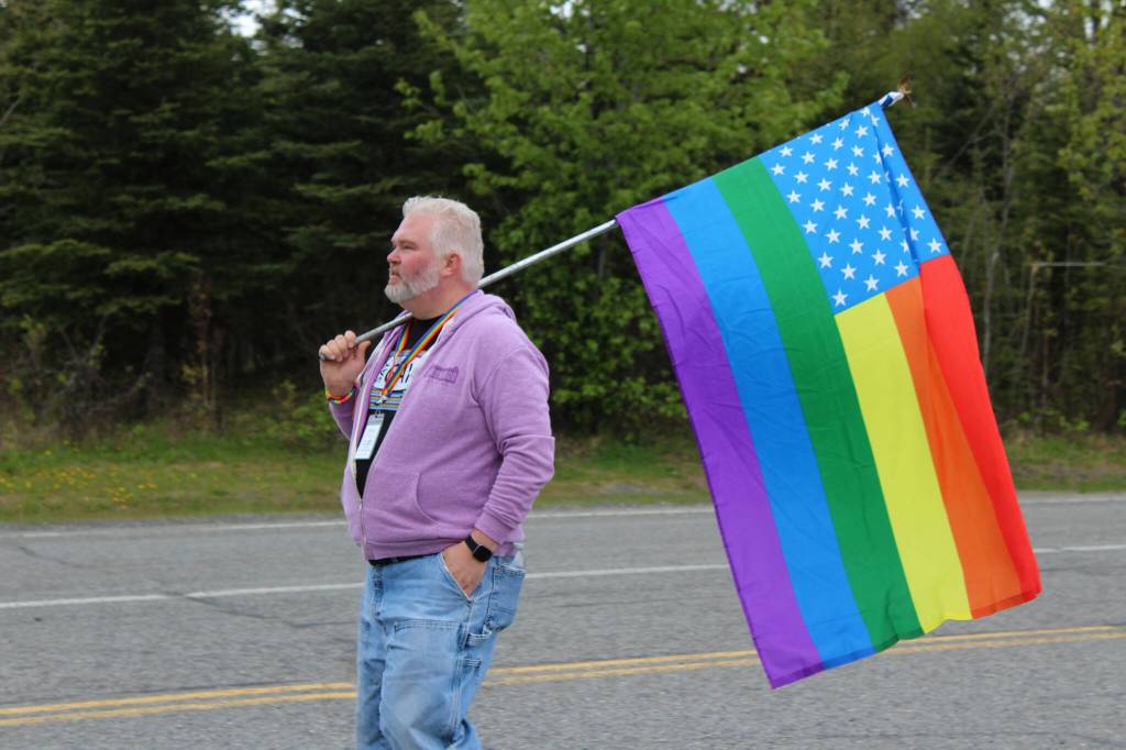 David Brighton holds a flag designating the end of the Soldotna Pride in the Park march group on Saturday, June 3, 2023 in Soldotna, Alaska. (Ashlyn OHara/Peninsula Clarion)