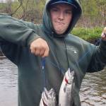 Hunter Kirby holds up the hatchery king salmon he bagged during the one-day youth fishery on the Ninilchik River on Wednesday, June 7, 2023 in Ninilchik, Alaska. Photo by Mike Booz