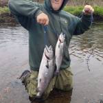 Hunter Kirby holds up the hatchery king salmon he bagged during the one-day youth fishery on the Ninilchik River on Wednesday, June 7, 2023 in Ninilchik, Alaska. Photo by Mike Booz
