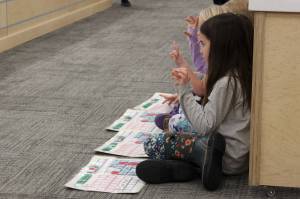 Mountain View Elementary School students use their hands to build works using methodology from the University of Florida Literacy Institute during a board of education meeting on Monday, Dec. 5, 2022, in Soldotna, Alaska. (Ashlyn OHara/Peninsula Clarion)