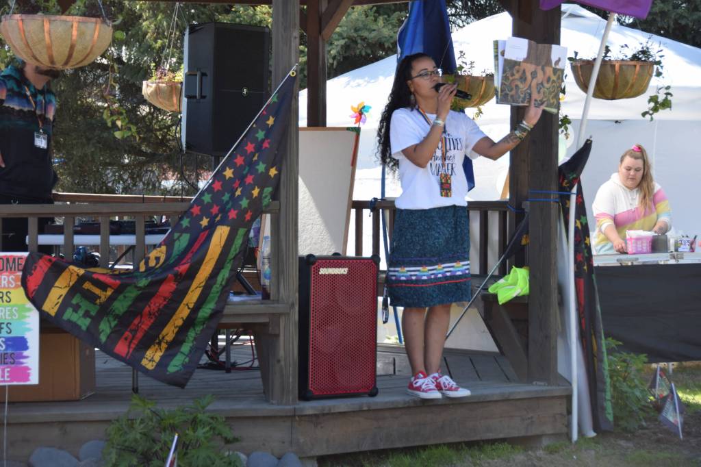 Educator Winter Marshall-Allen reads Maria Gianferraris Be A Tree! to the crowd gathered at WKFL Park for the Homer Pride Liberation Celebration on Saturday, June 17, 2023 in Homer, Alaska. (Delcenia Cosman/Homer News)
