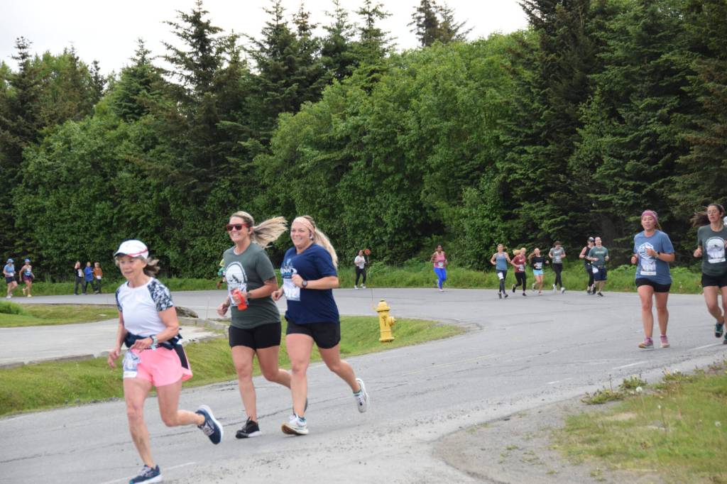 Runners participating in the Homer Spit Run 10K to the Bay race round the curve of Ben Walters Lane on Saturday, June 24, 2023 in Homer, Alaska. (Delcenia Cosman/Homer News)