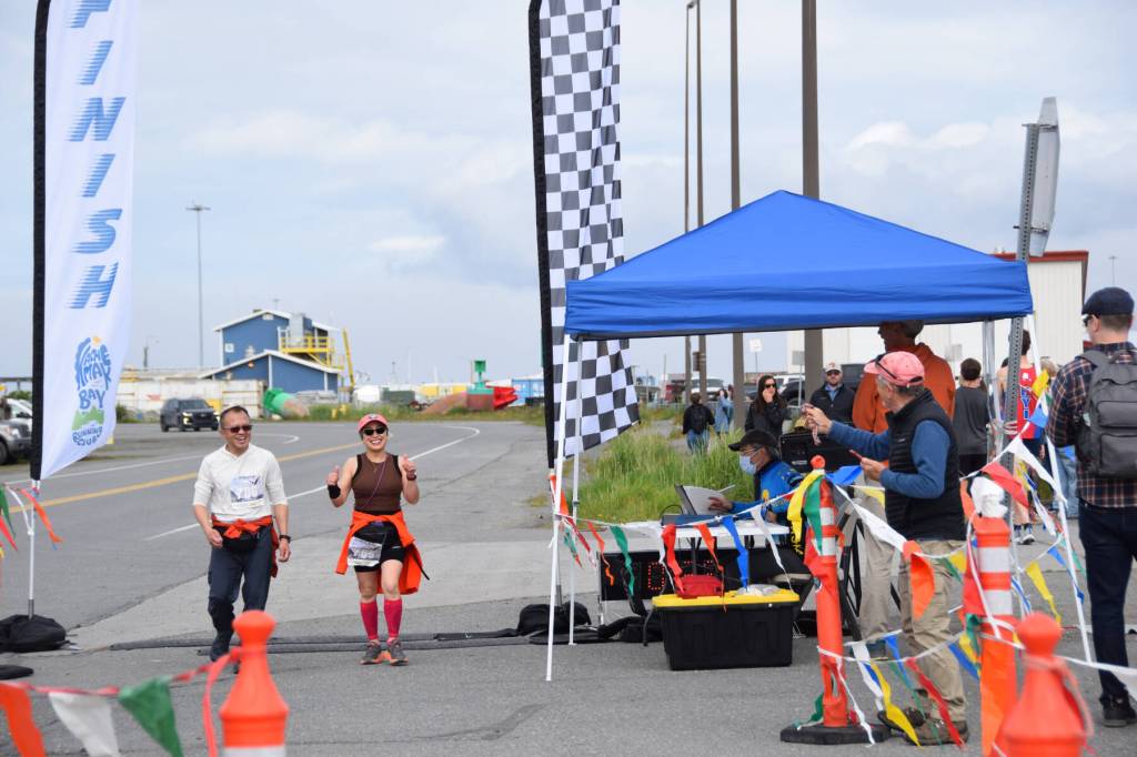 Participants walking in the Homer Spit Run 10K to the Bay cross the finish line at Lands End Resort on Saturday, June 24, 2023 in Homer, Alaska. (Delcenia Cosman/Homer News)