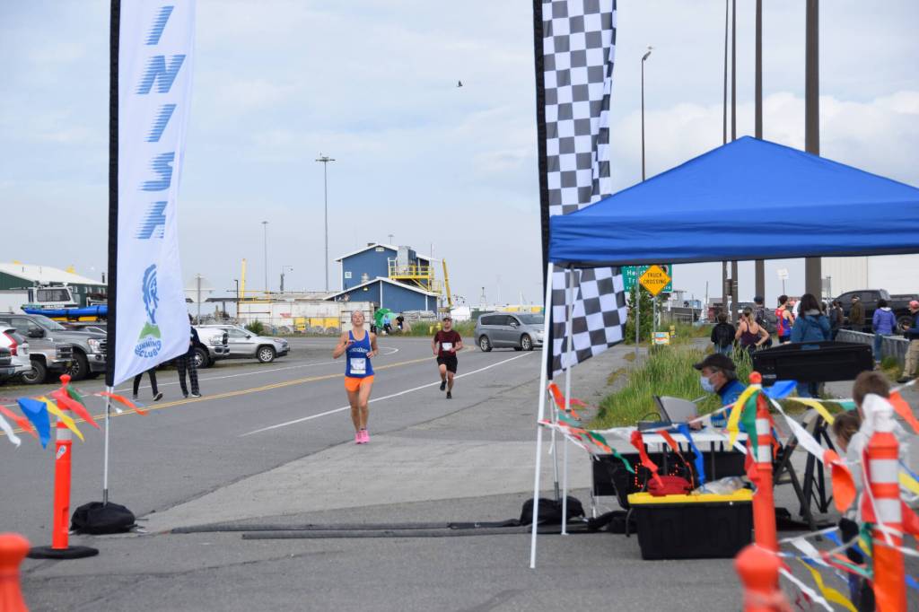 Amanda Cherok, running in the Homer Spit Run 10K to the Bay race, approaches the finish line at Lands End Resort on Saturday, June 24, 2023 in Homer, Alaska. (Delcenia Cosman/Homer News)
