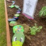 Stretch the painted rock snake, created by an anonymous community member, greets visitors to WKFL Park on Thursday, June 22, 2023 in the hopes of more rocks being added all summer long in Homer, Alaska. Photo by Christina Whiting