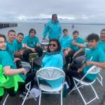 (from left to right) Daniel Paulson, Ransom Hayes, Bobby Hayes, Chris Anderson, Michael Bernard, William Wilson, Corbin Stuive, Marcus Wong, Tony Perez and Sandy K. Wilson, members of Salamatof Tribe Duldeldiht Youth Services, perform a traditional song and Idalqen, drum name meaning He is keeping the fire burning, during the Homer Chamber of Commerces first annual Summer Solstice Festival on Wednesday, June 21, 2023 on the Spit in Homer, Alaska. Photo by Christina Whiting