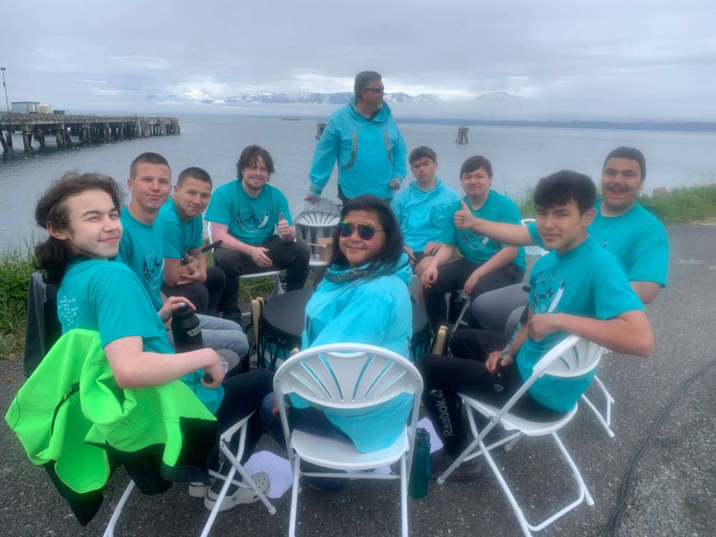 (from left to right) Daniel Paulson, Ransom Hayes, Bobby Hayes, Chris Anderson, Michael Bernard, William Wilson, Corbin Stuive, Marcus Wong, Tony Perez and Sandy K. Wilson, members of Salamatof Tribe Duldeldiht Youth Services, perform a traditional song and Idalqen, drum name meaning He is keeping the fire burning, during the Homer Chamber of Commerces first annual Summer Solstice Festival on Wednesday, June 21, 2023 on the Spit in Homer, Alaska. Photo by Christina Whiting