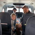 Kenai Aviation pilot Zachary Wells discusses the plane and flight schedule with community members Daniel Bunker (right) and Eli Mullen (left) during an impromptu Open House event on Wednesday, June 28, 2023 at the Homer Airport in Homer, Alaska. Photo by Christina Whiting