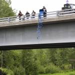 Anchor Point VFW Post 10221 Commander Charles Collins pours a tub of ducks into the Anchor River from the Anchor River Bridge on Sunday, July 2, 2023 in Anchor Point, Alaska. (Delcenia Cosman/Homer News)