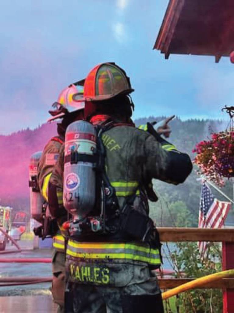 Homer Volunteer Fire Department deputy fire chief Joe Kahles, with other personnel, responds to a fire at the Fritz Creek General Store east of Homer on East End Road, early Thursday morning on July 6, 2023 in Fritz Creek, Alaska. Photo by Mark Kirko