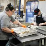 AlaSkins employees Lillie VanDevere (left) and Jeramie Davis (right) roll cod skins that will ultimately be sold as pet treats at AlaSkins on Thursday, July 6, 2023 in Soldotna, Alaska. (Ashlyn OHara/Peninsula Clarion)