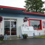 Flowers hang outside of AlaSkins on Thursday, July 6, 2023 in Soldotna, Alaska. (Ashlyn OHara/Peninsula Clarion)
