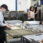 AlaSkins employee Jeramie Davis (left) slices and rolls cod skins that will ultimately be sold as pet treats at AlaSkins on Thursday, July 6, 2023 in Soldotna, Alaska. (Ashlyn OHara/Peninsula Clarion)