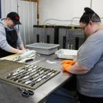 AlaSkins employees Jeramie Davis (left) and Lillie VanDevere (right) roll cod skins that will ultimately be sold as pet treats at AlaSkins on Thursday, July 6, 2023 in Soldotna, Alaska. (Ashlyn OHara/Peninsula Clarion)