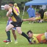 Photos by Jeff Helminiak/Peninsula Clarion
Ruairi Tuite of the Kenai River Wolfpack tries to break the tackles of Edgar Luna (top) and Keith McDaniel of the Fairbanks SunDawgs on Saturday at the Between the Tides Rugby Tourney at Millennium Square Field in Kenai.