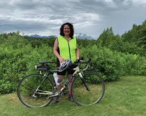 Pam Borland during a 100 mile summer training ride outside of Talkeetna, MP 50 of the Parks Highway, south view of Denali. Photo provided by Pam Borland
