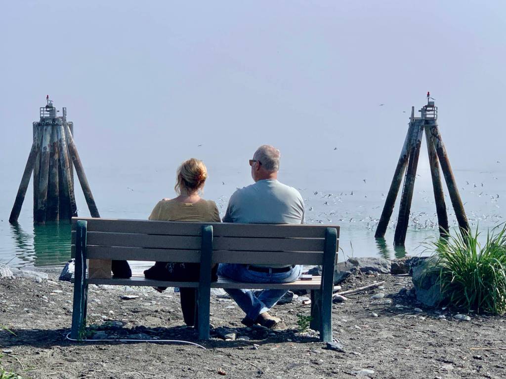 A couple enjoys the view from the end of the road at the park by Lands End Resort on Thursday, July 20, 2023 in Homer, Alaska. Photo by Christina Whiting