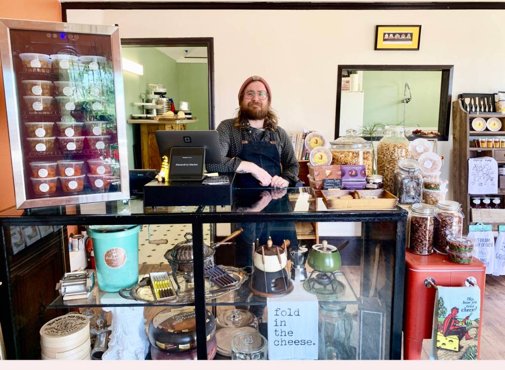 Community member Jacob Chrisman, photographed on Thursday, July 20, 2023, is the owner of Alasandros Market, a gourmet market specializing in imported cheeses, dry-cured meats and charcuterie platters, that opened on Heath Street in June. Photo by Christina Whiting