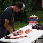Ransom Hayes fillets a salmon during a smoked salmon demonstration, part of Fish Week 2023, on Wednesday, July 19, 2023, at the Kenai National Wildlife Refuge Visitor Center in Soldotna, Alaska. (Jake Dye/Peninsula Clarion)