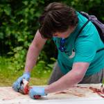 Chris Anderson fillets a salmon during a smoked salmon demonstration, part of Fish Week 2023, on Wednesday, July 19, 2023, at the Kenai National Wildlife Refuge Visitor Center in Soldotna, Alaska. (Jake Dye/Peninsula Clarion)