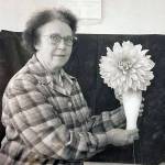 Mable Smith holds a large dahlia grown by her childhood friend Amanda Walker, wife of Kenais Pappy Walker, in October 1961. (Cheechako News photo)