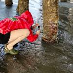 A young woman takes pictures on seastars on the Homer Spit during the recent -5 tide on Wednesday, Aug. 2, 2023 in Homer, Alaska. Photo by Christina Whiting