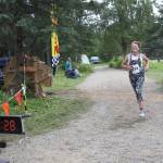 Emma Wilson smiles as she crosses the finish line in the inaugural Great Salmon Run 5K race on Saturday, Aug. 5, 2023 during Salmonfest at the Kenai Peninsula Fairgrounds in Ninilchik, Alaska. (Delcenia Cosman/Homer News)