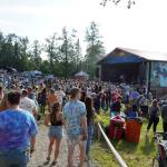 Attendees fill the space in front of the River Stage at Salmonfest in Ninilchik, Alaska, on Friday, Aug. 4, 2023. (Jake Dye/Peninsula Clarion)