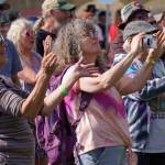 Attendees clap, record and dance along to a performance by Moonalice on the Ocean Stage at Salmonfest in Ninilchik, Alaska, on Friday, Aug. 4, 2023. (Jake Dye/Peninsula Clarion)