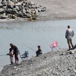 Parents show their kids how to cast their fishing lines during the youth-only coho salmon fishery on Saturday, Aug. 5, 2023 at the Nick Dudiak Fishing Lagoon on the Homer Spit in Homer, Alaska. (Delcenia Cosman/Homer News)