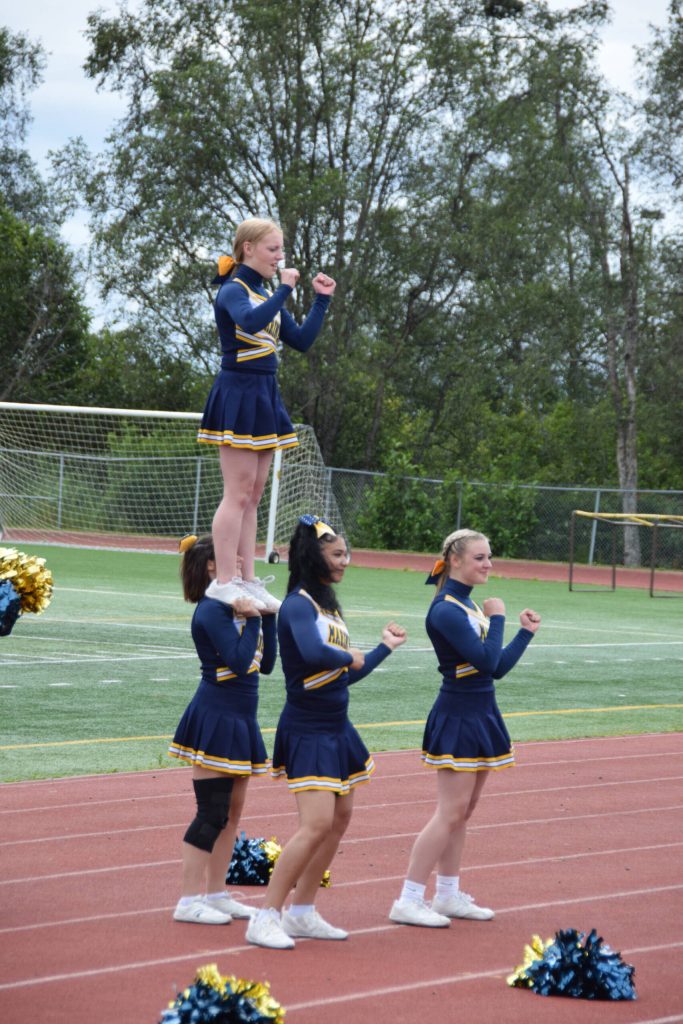 The Homer High cheerleaders keep the crowds energy up during the home opener varsity football game on Saturday, Aug. 12, 2023 in Homer, Alaska. (Delcenia Cosman/Homer News)