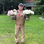 Sean Martin with flowers at Diamond Ridge Peony Farm in Homer on August 11.