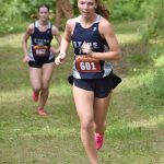 Soldotna junior Annie Burns leads SoHi senior Kaytlin McAnelly on the way to victory in the junior-senior girls race at the Class Races on Monday, Aug. 14, 2023, at Nikiski High School in Nikiski, Alaska. (Photo by Jeff Helminiak/Peninsula Clarion)