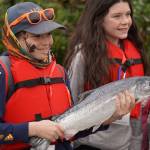 Joshua Guzman holds up a salmon he caught during the Kenai River Junior Classic in Soldotna, Alaska, on Wednesday, Aug. 9, 2023. (Jake Dye/Peninsula Clarion)