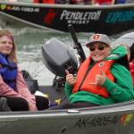 Boats with kids, guides, and freshly caught salmon return to shore at the Kenai River Junior Classic in Soldotna, Alaska, on Wednesday, Aug. 9, 2023. (Jake Dye/Peninsula Clarion)