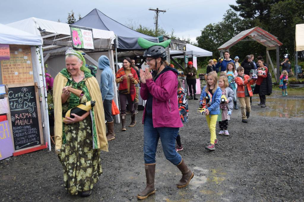 Reigning Zucchini Queenie Luba Dorvall (front left) leads the parade around the Homer Farmers Market at the Zucchini Festival on Saturday, Aug. 26, 2023 in Homer, Alaska. (Delcenia Cosman/Homer News)
