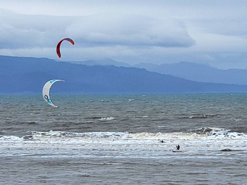 Adventurous kitesurfers brave the cold waters of Kachemak Bay next to the Spit on Saturday, Sept. 2, 2023 in Homer, Alaska. (Delcenia Cosman/Homer News)