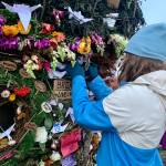 A community member places a message on the 2022 Burning Basket, Breathe, in Homer, Alaska. Photo by Christina Whiting