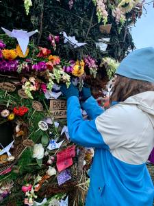 A community member places a message on the 2022 Burning Basket, Breathe, in Homer, Alaska. Photo by Christina Whiting