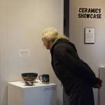 A community member peruses the ceramics on display at Homer Council on the Arts First Friday showcase on Sept. 1 in Homer, Alaska. (Delcenia Cosman/Homer News)