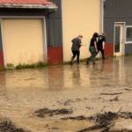 The Bagel Shop employees and owner Mikela Aramburu wade through the mud to get to the shop on Saturday, Aug. 26, 2023 in Homer, Alaska. Photo provided by Mikela Aramburu
