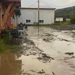 Stormwater and debris washes down from East End Road to The Bagel Shop parking lot during the heavy rains and subsequent flooding on Saturday, Aug. 26, 2023 in Homer, Alaska. Photo provided by Mikela Aramburu
