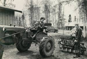 Rusty Lancashire backs up the family tractor so her husband Larry can connect it to the disc for their fields. (1954 photo by Bob and Ira Spring for Better Homes & Garden magazine)