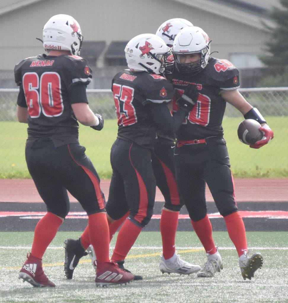 Kenai Centrals Bobby Hayes (far right) celebrates his touchdown run against Homer with teammates on Saturday, Sept. 2, 2023, at Ed Hollier Field at Kenai Central High School in Kenai, Alaska. (Photo by Jeff Helminiak/Peninsula Clarion)