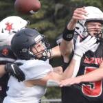 Kenai Central's Sawyer Vann and Zeke Yragui break up a pass intended for Homer's Chris Martishev on Saturday, Sept. 2, 2023, at Ed Hollier Field at Kenai Central High School in Kenai, Alaska. (Photo by Jeff Helminiak/Peninsula Clarion)