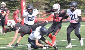 Homers Austin Briscoe tackles Kenai Centrals Zeke Yragui just short of the end zone Saturday, Sept. 2, 2023, at Ed Hollier Field at Kenai Central High School in Kenai, Alaska. (Photo by Jeff Helminiak/Peninsula Clarion)